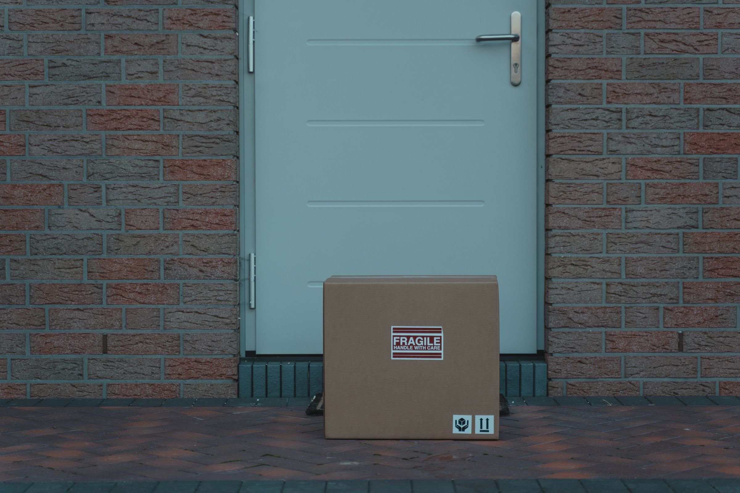 A cardboard shipping box waiting on a front doorstep
